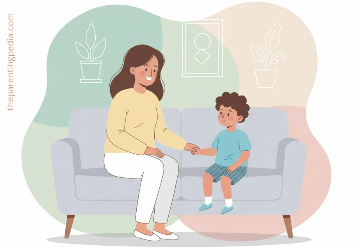 Mother calmly talking with her child on the sofa, demonstrating positive and effective discipline through communication and support.